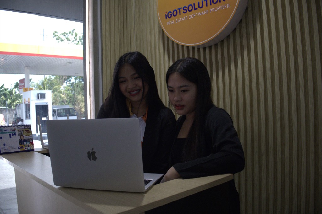 Team members collaborating with coffee in hand at the iGotSolutions office